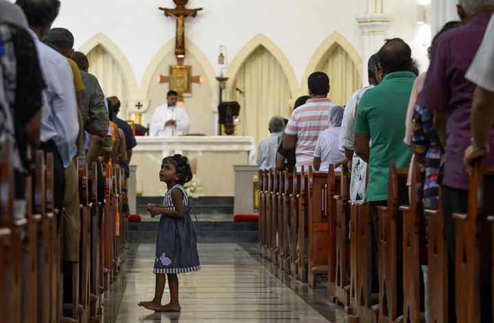 Sri Lankan Catholic devotees pray during a mass at the St. Theresa's church on Sunday.