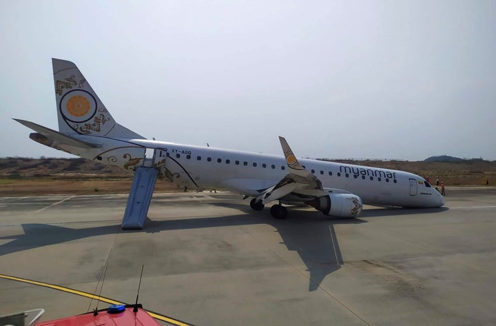 A Myanmar National Airlines plane sits on the runway at Mandalay International airport on Sunday after its pilot was forced t