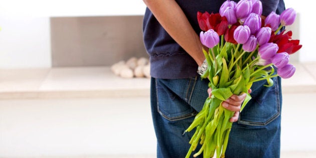 Romantic man giving flowers to his girlfriend