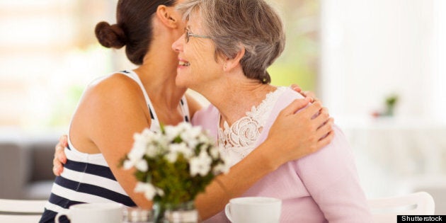 young woman hugging senior...