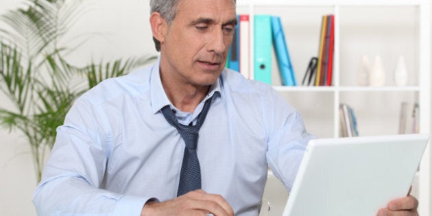 mature businessman working on his desk