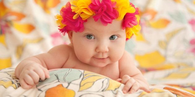 baby in a wreath of flowers