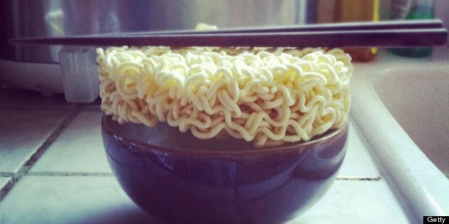 Asian instant noodles in bowl in front of rice cooker.