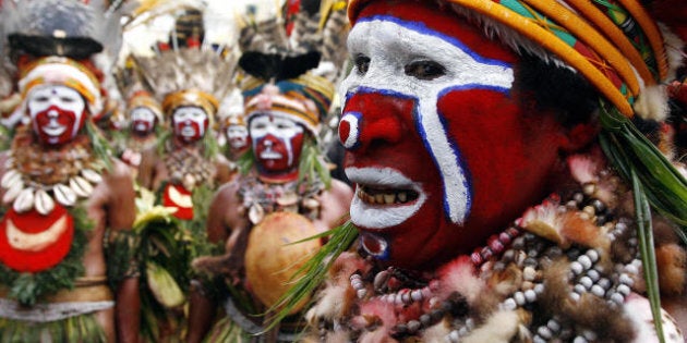 Goroka, PAPUA NEW GUINEA: Kuna women from Anglimp in the Western Highlands arrive at the 50th Goroka singsing (cultural show) in what is believed to be the largest gathering of indigenous tribes in the world, 16 September 2006. Over 90 tribes from all over Papua New Guinea -- the world's most culturally diverse nation -- have gathered in Goroka for the annual festival of traditional dance on Independence Day. AFP PHOTO/Torsten BLACKWOOD (Photo credit should read TORSTEN BLACKWOOD/AFP/Getty Images)