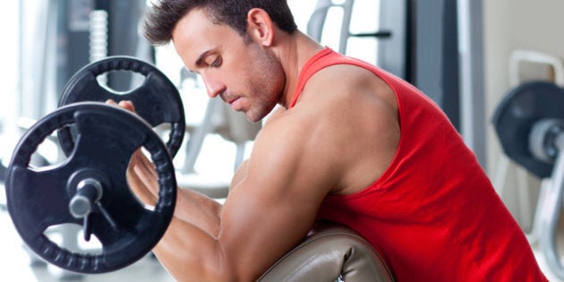 man with weight training equipment on sport gym club