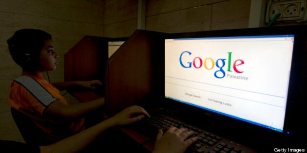 A Palestinian boy opens the Palestinian homepage of Google's search engine reading 'Palestine' at an internet cafe in east Jerusalem on May 3, 2013. Internet giant Google has recognised the Palestinians' upgraded UN status, placing the name 'Palestine' on its search engine instead of 'Palestinian Territories,' the US company said, raising the ire of Israel. AFP PHOTO/AHMAD GHARABLI (Photo credit should read AHMAD GHARABLI/AFP/Getty Images)