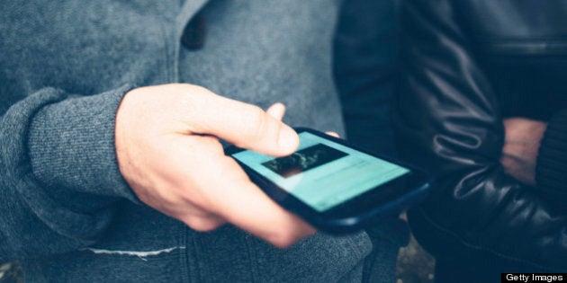 Man using a smartphone to surf in internet. Tilt shift lens.