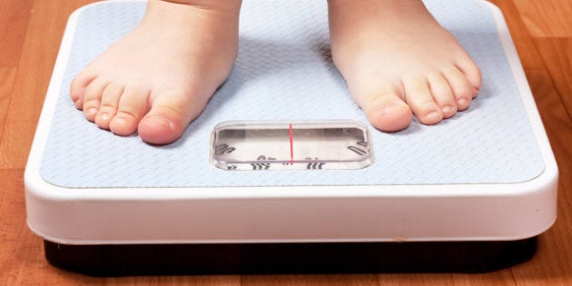 Closeup view of scales on a floor and kids feet