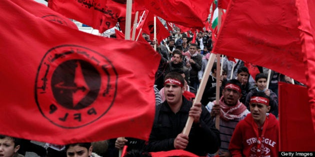 Supporters of the Popular Front for the Liberation of Palestine (PFLP) carry the party flag during a rally to mark the 45th anniversary of the establishment of the PFLP in the West Bank city of Nablus on December 8, 2012. AFP PHOTO/JAAFAR ASHTIYEH (Photo credit should read JAAFAR ASHTIYEH/AFP/Getty Images)