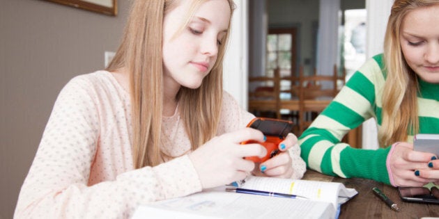 Girls sitting at table studying