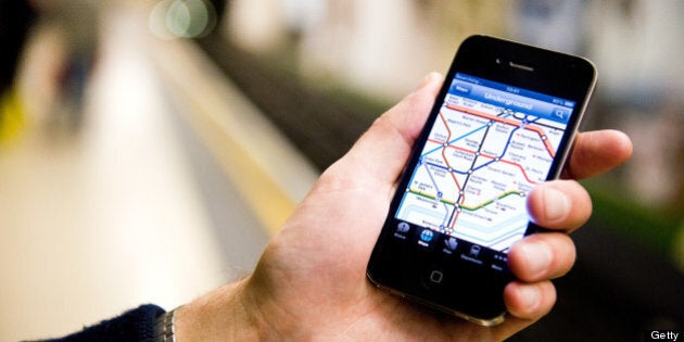 A man using an iPhone to view a map of the London Underground whilst waiting for a tube train, October 4, 2012. (Photo by Kevin Nixon/Future Publishing via Getty Images)