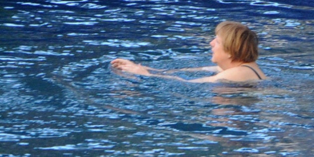 German Chancellor Angela Merkel takes a bath in the swimming pool of the Aphrodite Terme in the coastal town of Sant'Angelo d'Ischia on the southern Italy's Island of Ischia during their Easter holiday on March 31, 2013. AFP PHOTO/MARIO LAPORTA (Photo credit should read MARIO LAPORTA/AFP/Getty Images)