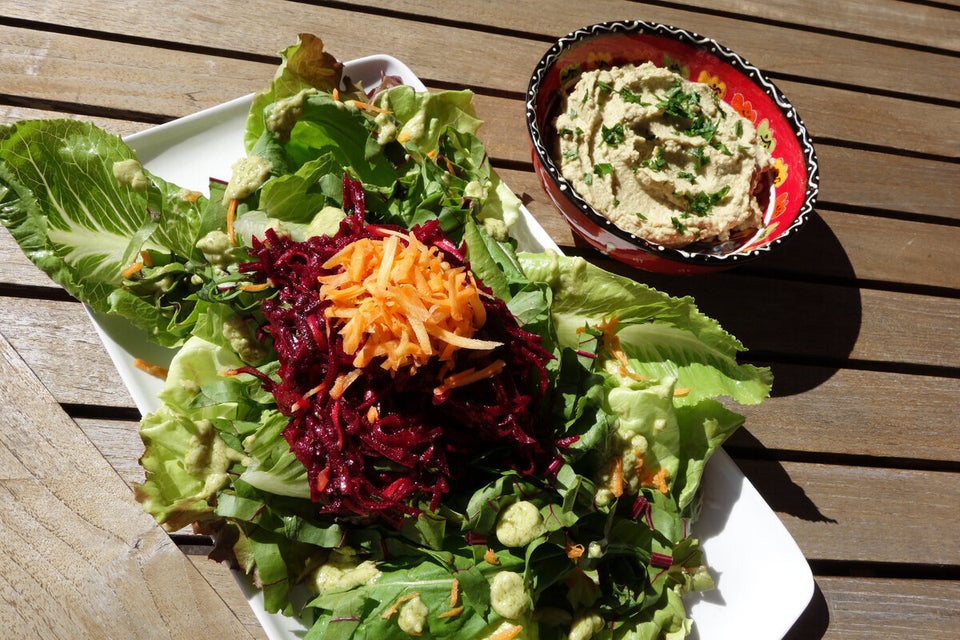 Mixed leafy greens with chopped almonds and creamy avocado dressing