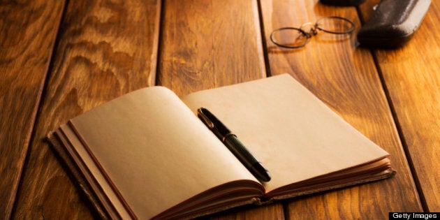 Vintage desk set up. Antique eyeglasses, old notepad - book, fountain pen, spectacles on wooden table.