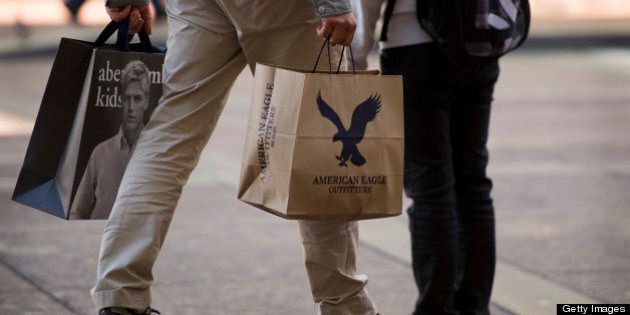A shopper carries an American Eagle Outfitters Inc. bag and an Abercrombie & Fitch Co. bag in San Francisco, California, U.S., on Thursday, Aug. 16, 2012. American Eagle Outfitters Inc., the teen-apparel retailer with more than 1,000 stores in North America, is scheduled to release second-quarter earnings data before the open of U.S. financial markets on Aug. 22. Photographer: David Paul Morris/Bloomberg via Getty Images