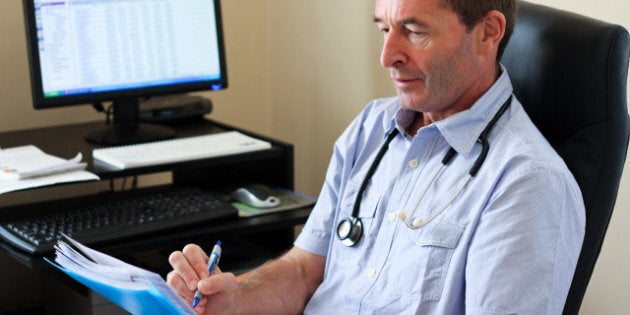 doctor writing on a document in ...