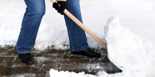 Woman is shovelling snow