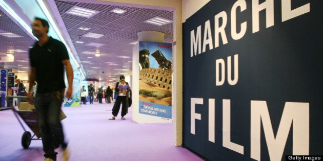A man walks by the sign of the Marche du Film (film market) at the 63rd Cannes Film Festival on May 12, 2010 in Cannes. AFP PHOTO / LOIC VENANCE (Photo credit should read LOIC VENANCE/AFP/Getty Images)