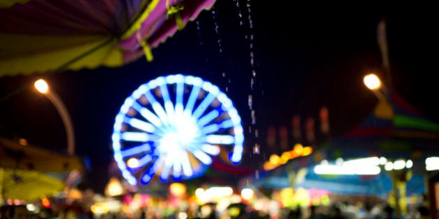 Rain poured down on the midway Saturday night at the CNE. (Photo by Lucas Oleniuk/Toronto Star via Getty Images)