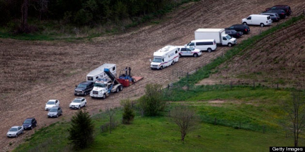 NORTH DUMFRIES, ON - MAY 14: Vehicles near the farm where police are investigating the death of Tim Bosma at 2548 Roseville Rd. in North Dumfries Township. Bosma, the Ancaster man who disappeared more than a week ago after leaving his home with men who came to test drive his truck, has been found dead, Hamilton police announced Tuesday morning. (Andrew Francis Wallace/Toronto Star via Getty Images)