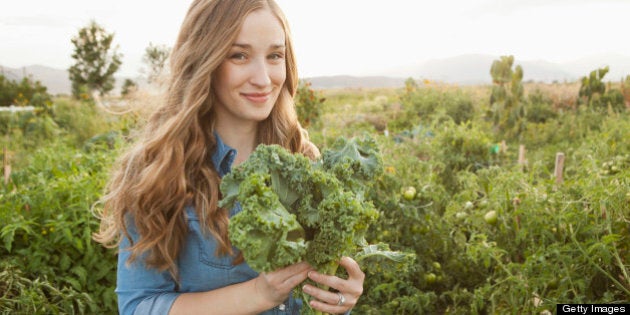 USA, Utah, Salt Lake City, Portrait of young woman holding kale