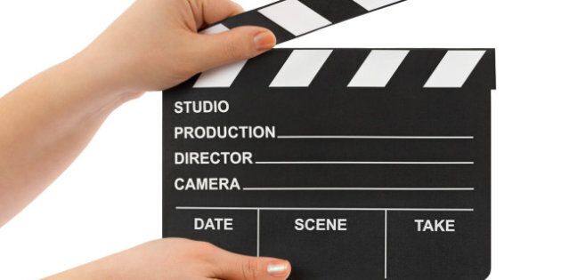 Hands with cinema clapboard isolated on white background