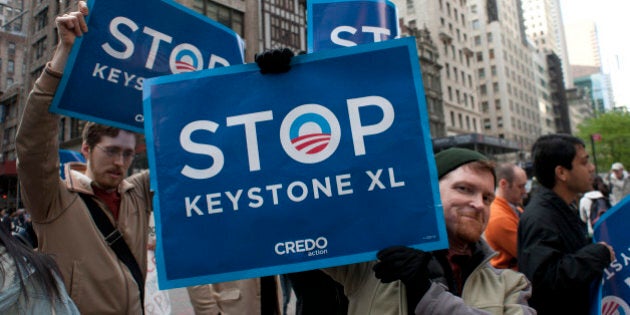 Environmental activists march through midtown protesting the proposed Keystone XL pipeline, May 13, 2013 in New York. The group marched from Bryant Park through midtown to rally outside the Waldorf Astoria hotel where President Obama was attending a fundraiser. AFP PHOTO/Don Emmert (Photo credit should read DON EMMERT/AFP/Getty Images)