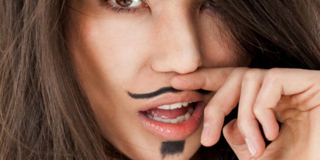 Close-up of female face with moustache dendy makeup