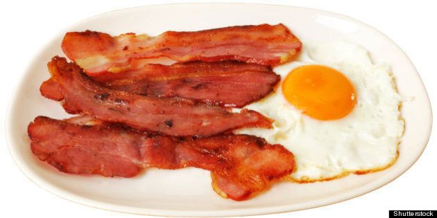 fried egg with bacon on white...