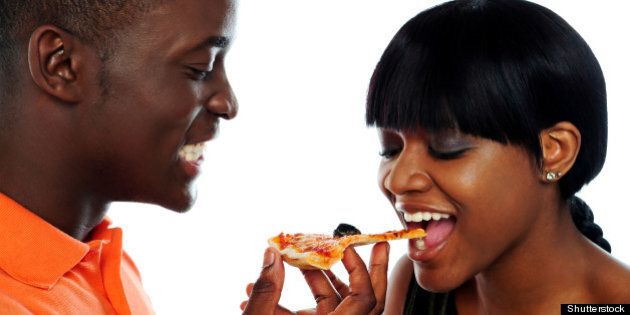 beautiful african couple eating ...