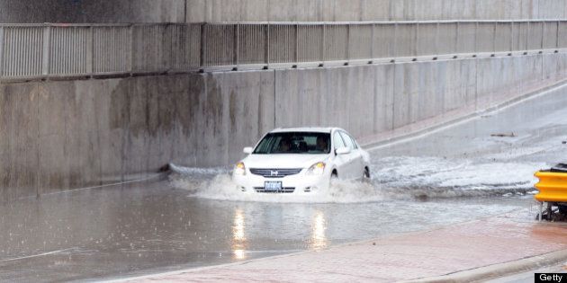 TORONTO, ON - JUNE 28: Drivers attempt to drive through flooded area on North Queen in Etobicoke. (Vince Talotta/Toronto Star via Getty Images)