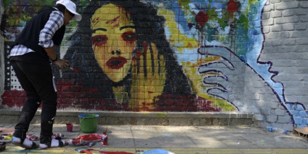 Indian artists create wall paintings during the 'Design The Change' wall art event in New Delhi on February 24, 2013. The activity brought together more than 500 professional and budding artists on the same platform to create the wall art. Artists used their imagination and creativity to give justice to the theme and depicted the essence of transformation needed for the betterment of society. AFP PHOTO/SAJJAD HUSSAIN (Photo credit should read SAJJAD HUSSAIN/AFP/Getty Images)