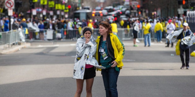 BOSTON - APRIL 15: A runner was comforted following two explosions on Boylston Street in Boston near the finish line of the Boston Marathon. (Photo by Aram Boghosian for The Boston Globe via Getty Images)