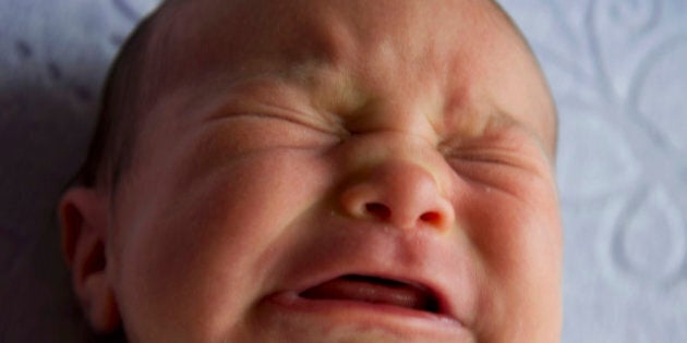 Portraits of a newborn baby girl crying