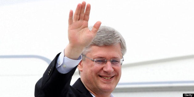 BELFAST, UNITED KINGDOM - JUNE 17: Canadian Prime Minister Stephen Harper waves as he arrives at Belfast International Airport on June 17, 2013 in Belfast, Northern Ireland. The two-day G8 summit, hosted by UK Prime Minister David Cameron, is being held in Northern Ireland for the first time. Leaders from the G8 nations have gathered to discuss numerous topics with the situation in Syria expected to dominate the talks. (Photo by Peter Muhly - WPA Pool/Getty Images)