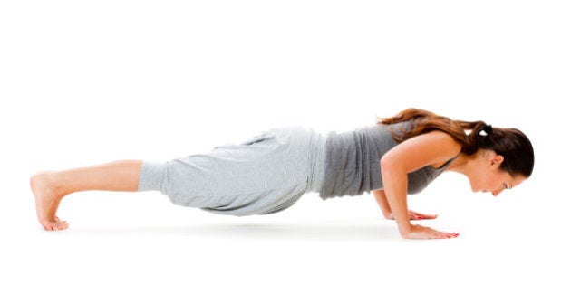 young woman doing push up...