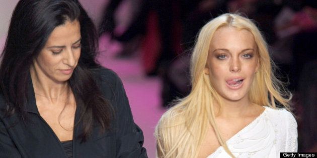 Spanish designer Estrella Arch (L) and US actress Lindsay Lohan appointed as artistic advisor acknowledges the public at the end of Emanuel Ungaro ready-to-wear Spring-Summer 2010 fashion show on October 4, 2009 in Paris. AFP PHOTO PIERRE VERDY (Photo credit should read PIERRE VERDY/AFP/Getty Images)