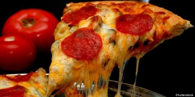 slice of pepperoni pizza being...