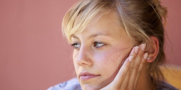 pensive young woman looks away