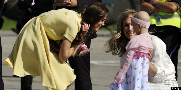 Catherine, the Duchess of Cambridge meets with 6-year-old Diamond Marshall as she arrives with Prince William at Calgary International Airport in Calgary on July 7, 2011. The Make-a-Wish Foundation arranged for Marshall, a cancer patient, to greet the royal couple. AFP PHOTO / TIMOTHY A. CLARY (Photo credit should read TIMOTHY A. CLARY/AFP/Getty Images)