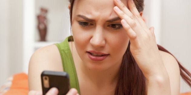 shocked and frustrated woman with cellphone