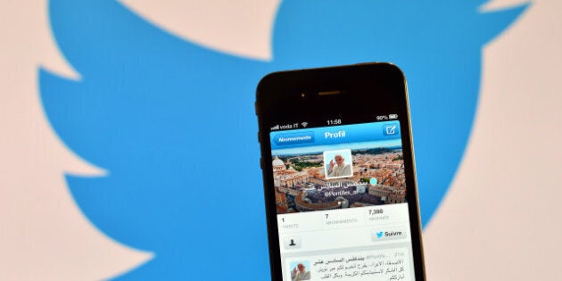 A smartphone showing the first twitter message of Pope Benedict XVI in Arabic is held in front of a computer showing the logo of Twitter on December 12, 2012 in Rome. Pope Benedict XVI sent his first Twitter message from a digital tablet on Wednesday during his weekly general audience using the handle @pontifex, blessing his hundreds of thousands of new Internet followers. AFP PHOTO / GABRIEL BOUYS (Photo credit should read GABRIEL BOUYS/AFP/Getty Images)