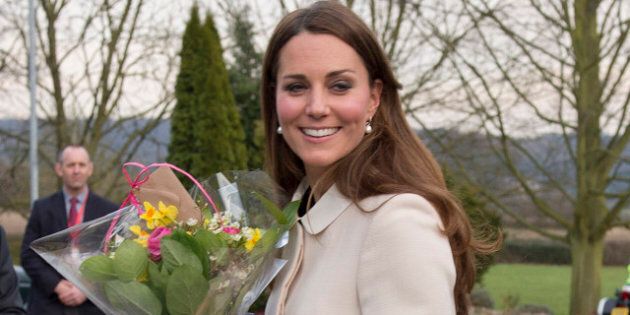 SAUNDERTON, ENGLAND - MARCH 19: Catherine, Duchess of Cambridge carries flowers as she visits the offices of Child Bereavement UK on March 19, 2013 in Saunderton, Buckinghamshire. (Photo by Paul Edwards - WPA Pool/Getty Images)