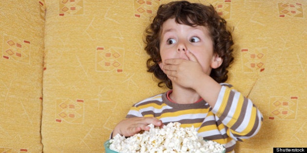 adorable child watching tv in...