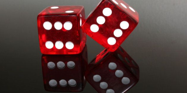 two red dice on black gloss...
