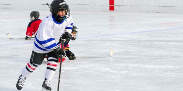 a young hockey player races...