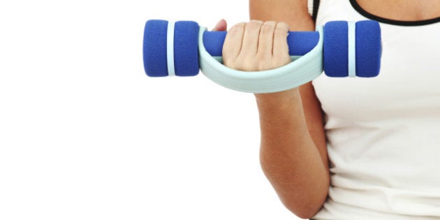 dumbbells in woman hands...