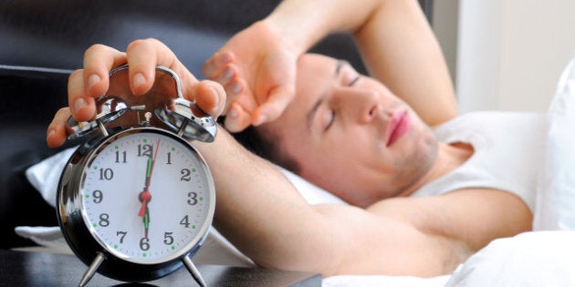 man sleeping with alarm clock...