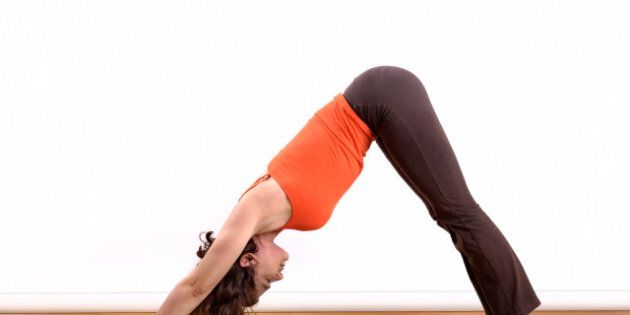 woman holding a downward facing ...