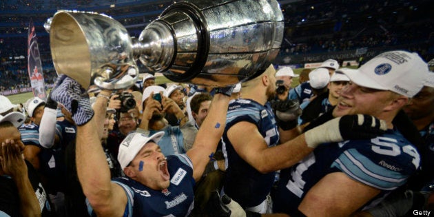 TORONTO, ON - NOVEMBER 25: Toronto Argonaut Jeff Johnson, 33, hoists the Grey Cup after the Argos beat...